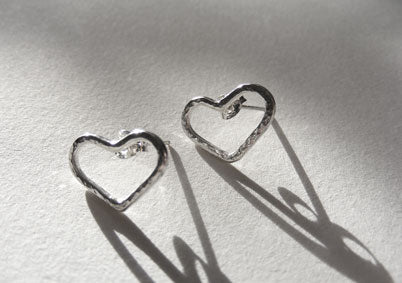 2 two pairs of silver signature heart studs