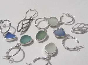 selection of silver blue green and clear beach sea glass earrings made in devon