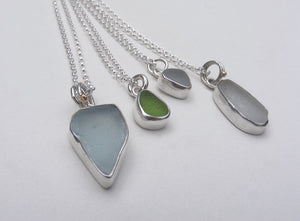 selection of silver beach sea glass pendants and necklaces