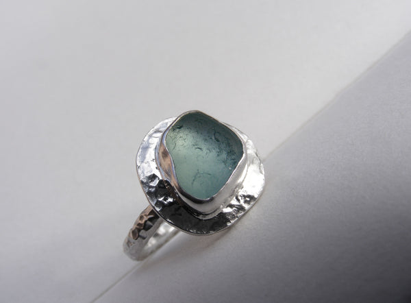 Sea Foam sea glass ring set on a heavily hammered recycled silver band